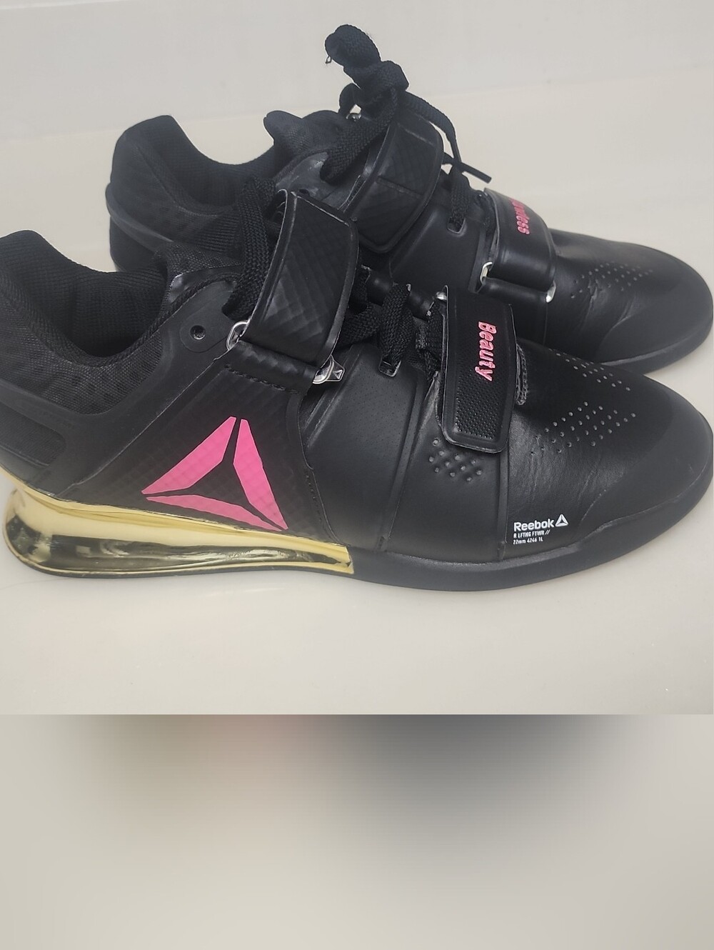 Reebok Black Athletic Training Shoes with Pink Logo and Gold Heel